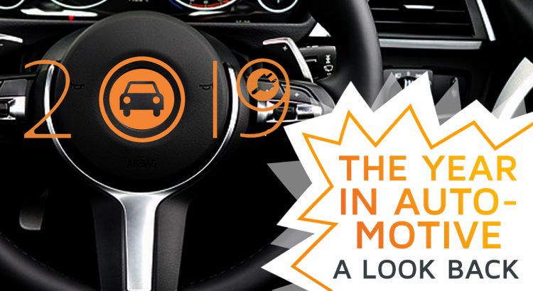 A car's dashboard, with the number 2019 stuck to it, symbolizing the automotive market of the year 2019 in this review article.